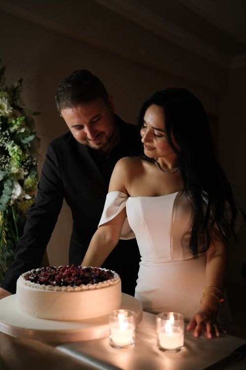 Couple cutting their wedding cake