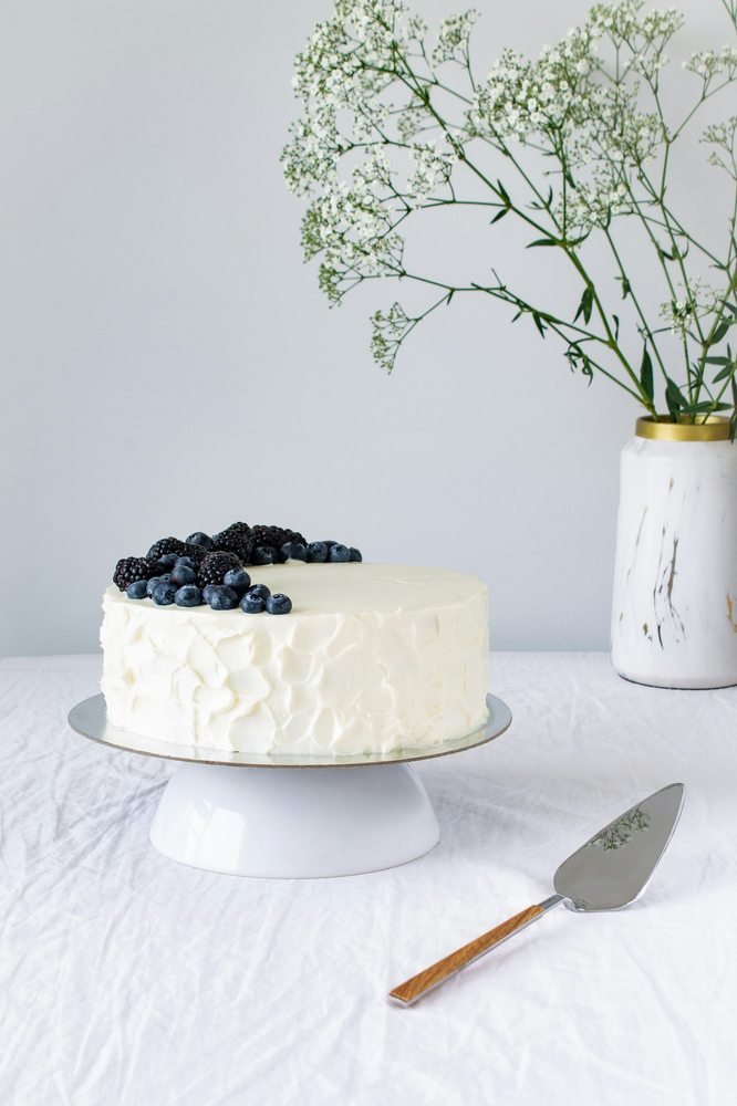 White cake topped with blackberries