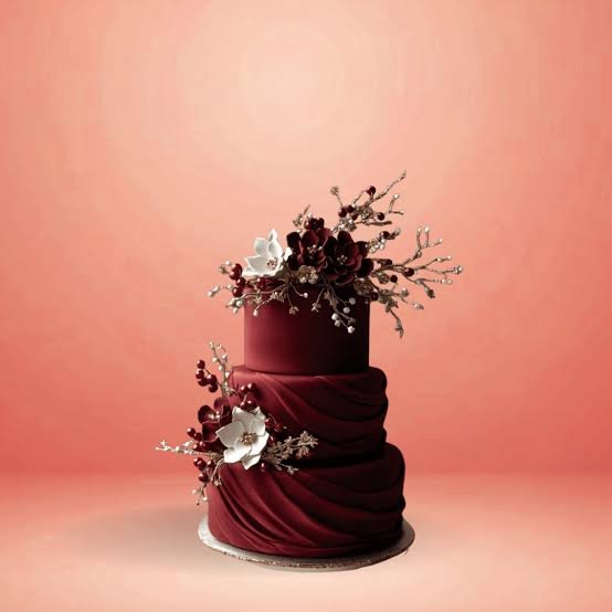 Iced wedding cake finished with sugar flowers